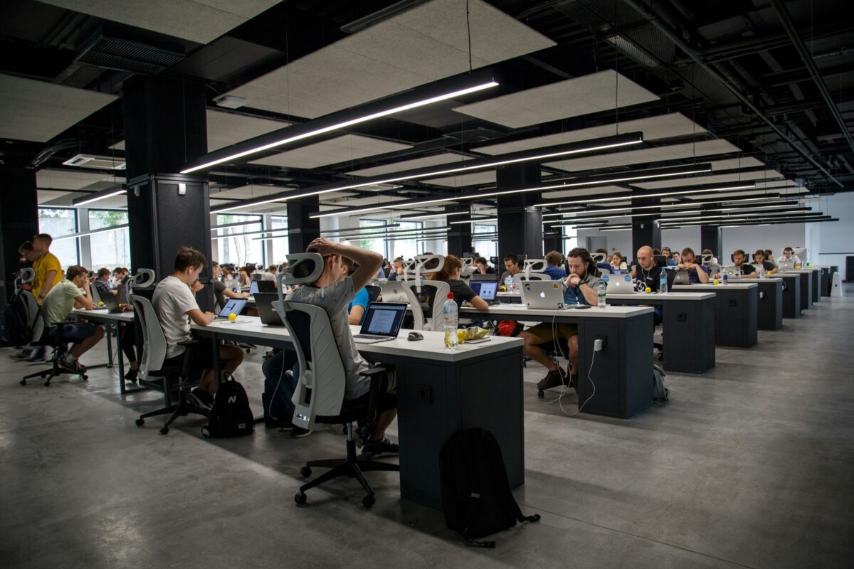 Picture of many employees sitting in open office working