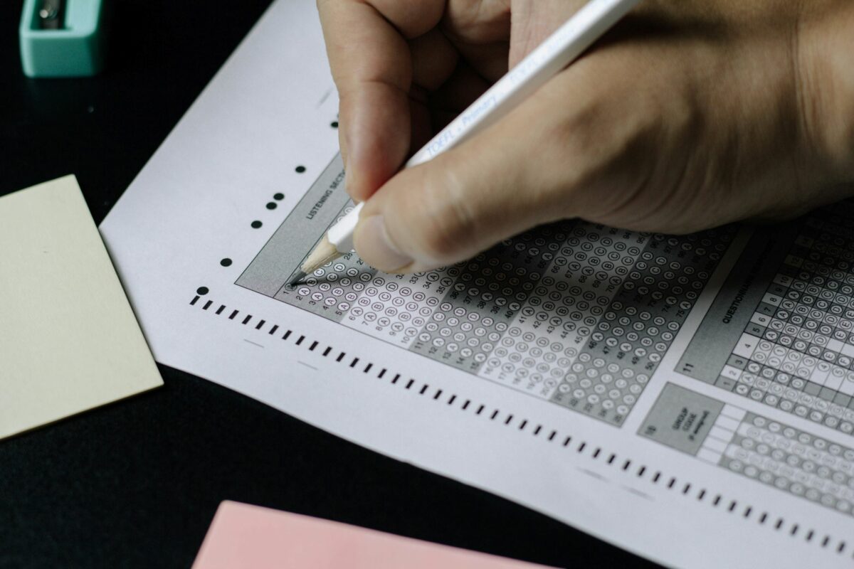 Picture of someone filling out a bubble sheet for an exam